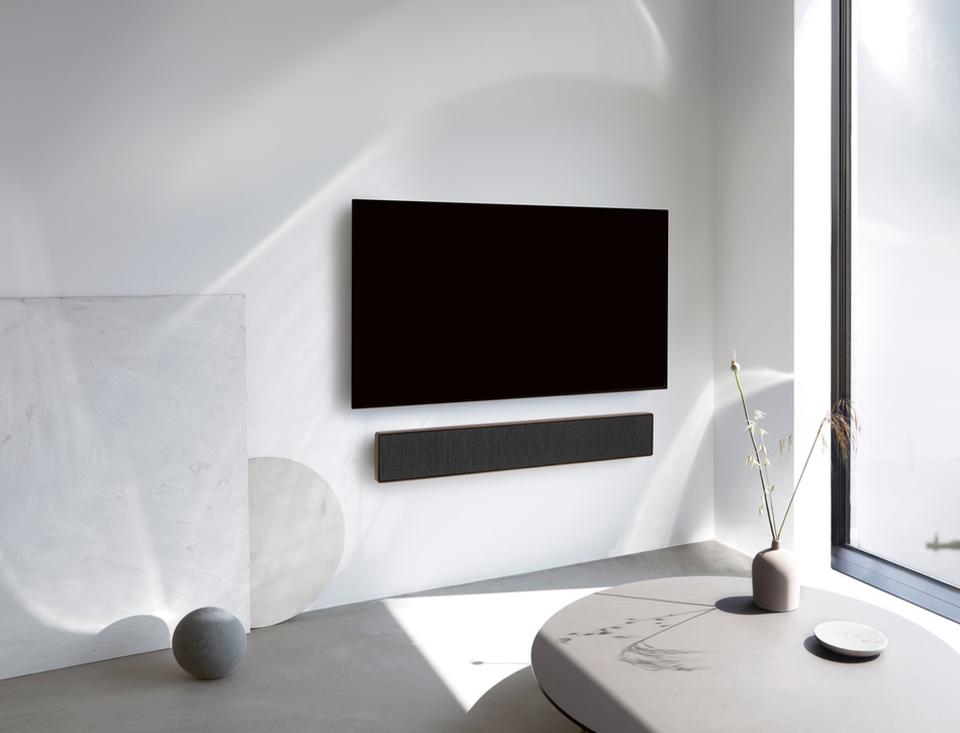 Beosound Stage mounted on a wall beneath a TV