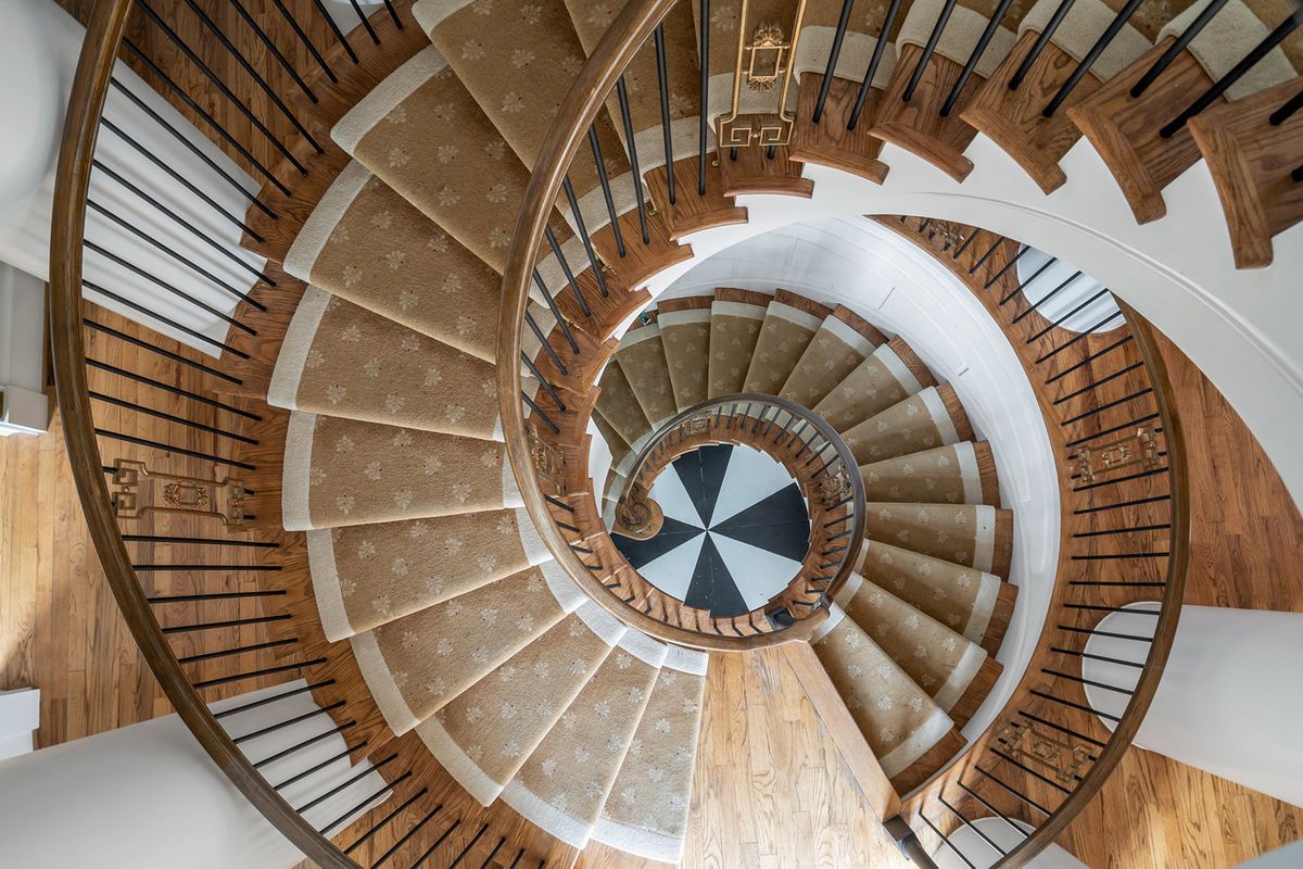 A huge spiral staircase with a checkerboard finish at bottom. 