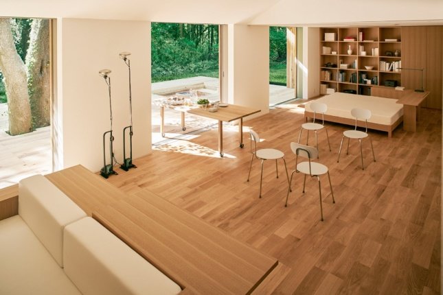 Looking out into a living room with wood furniture