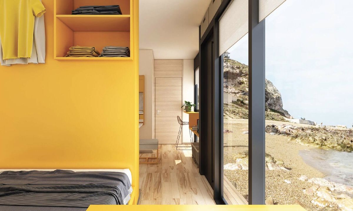 Bedroom with wall of windows and yellow paint