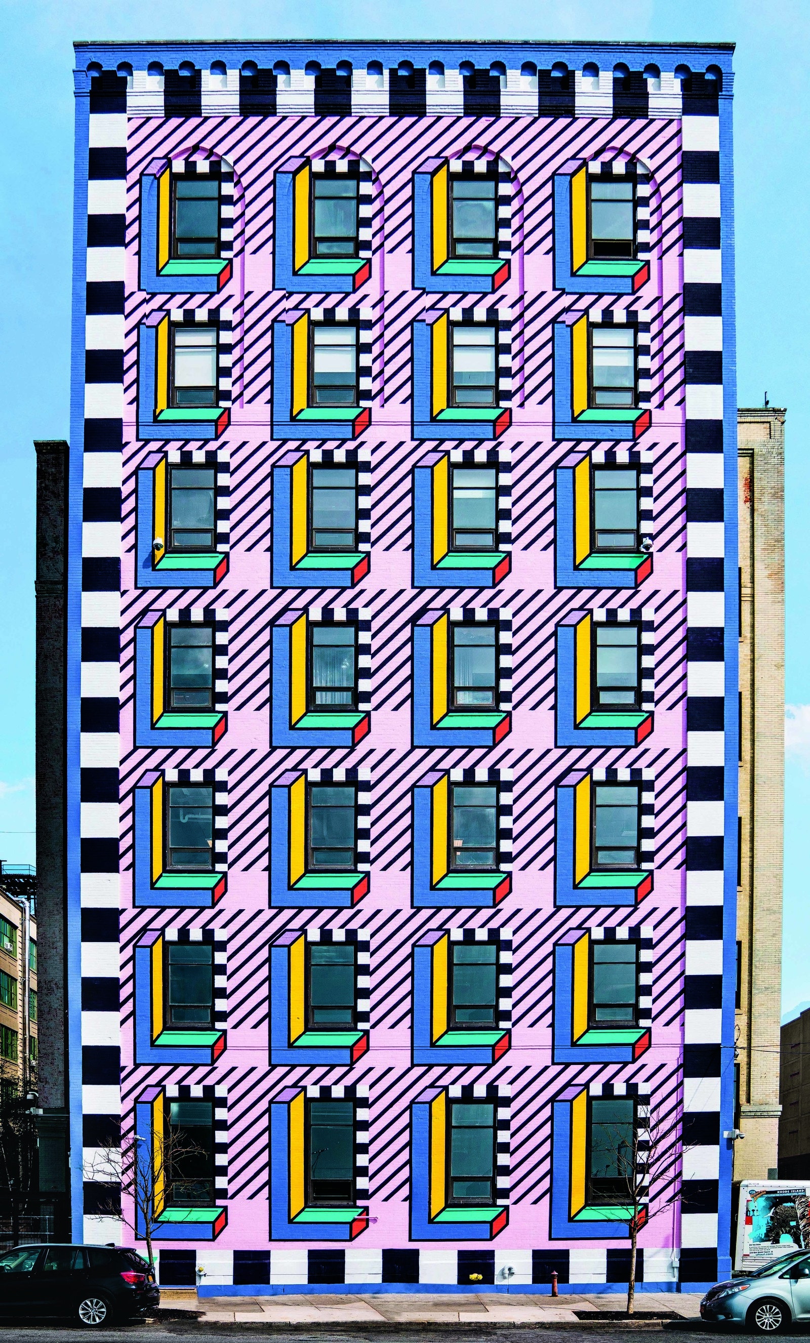 a tall skinny building with colorful tiles