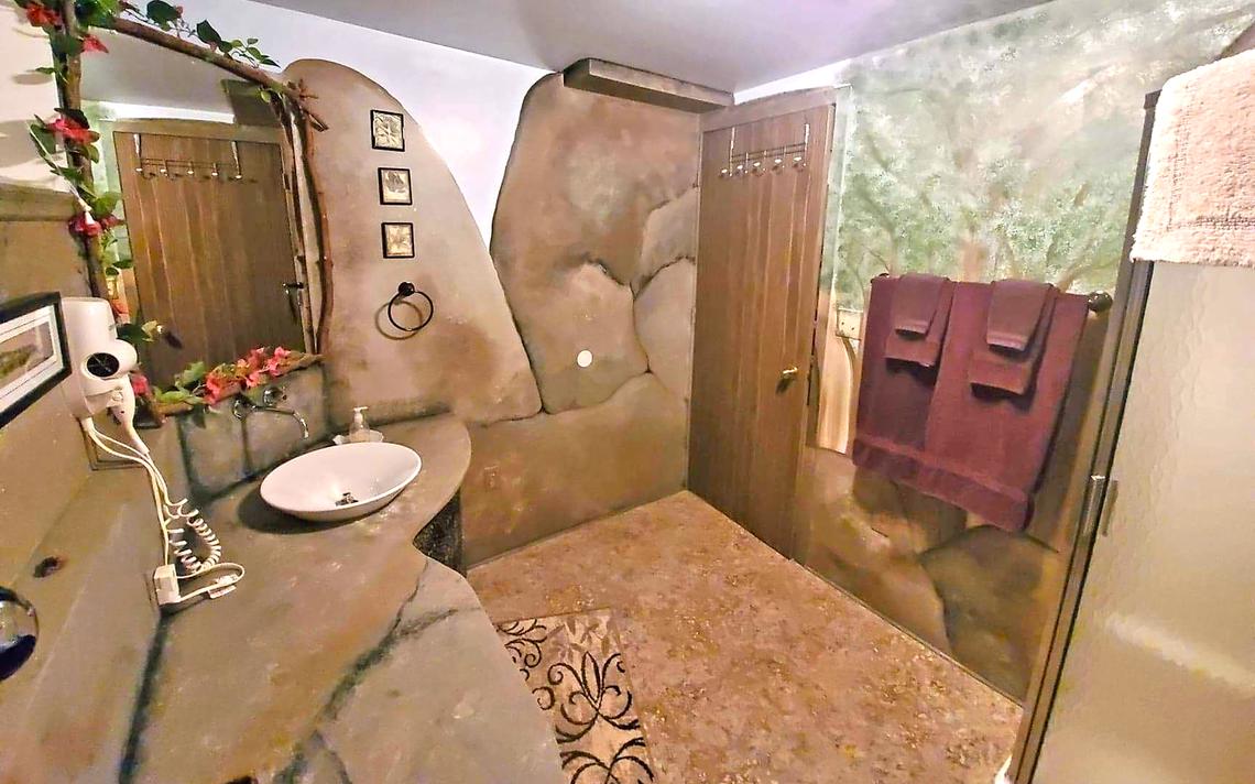 The Grotto's bathroom features a stylish waterfall sink and walk-in shower that blend well with the room's natural theme. (Bria Barton | Bemidji Pioneer)