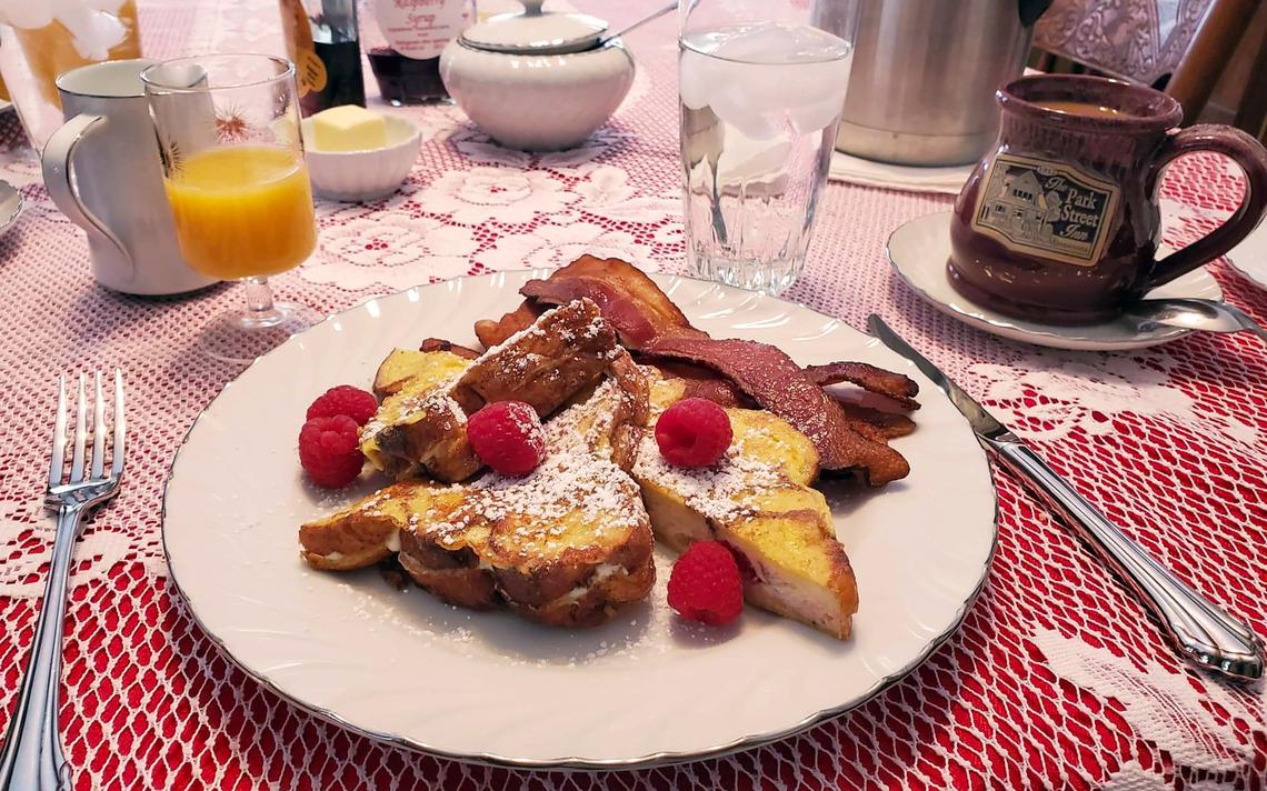 Park Street Inn's signature gourmet breakfast is raspberry-stuffed French toast. On this occasion, it was served with crispy bacon as well as fresh fruit, muffins, coffee and orange juice. (Bria Barton | Bemidji Pioneer)