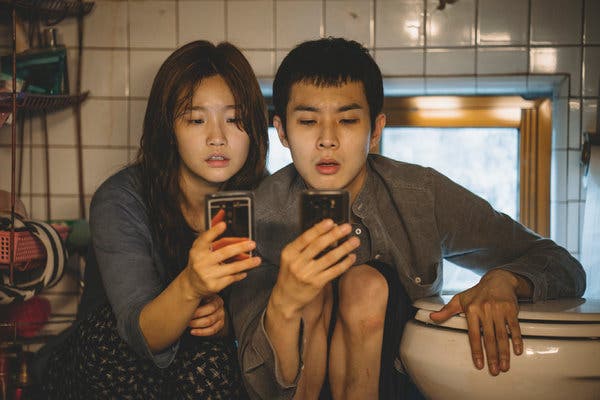 Park So Dam and Choi Woo Shik as members of the impoverished Kim family in “Parasite.”