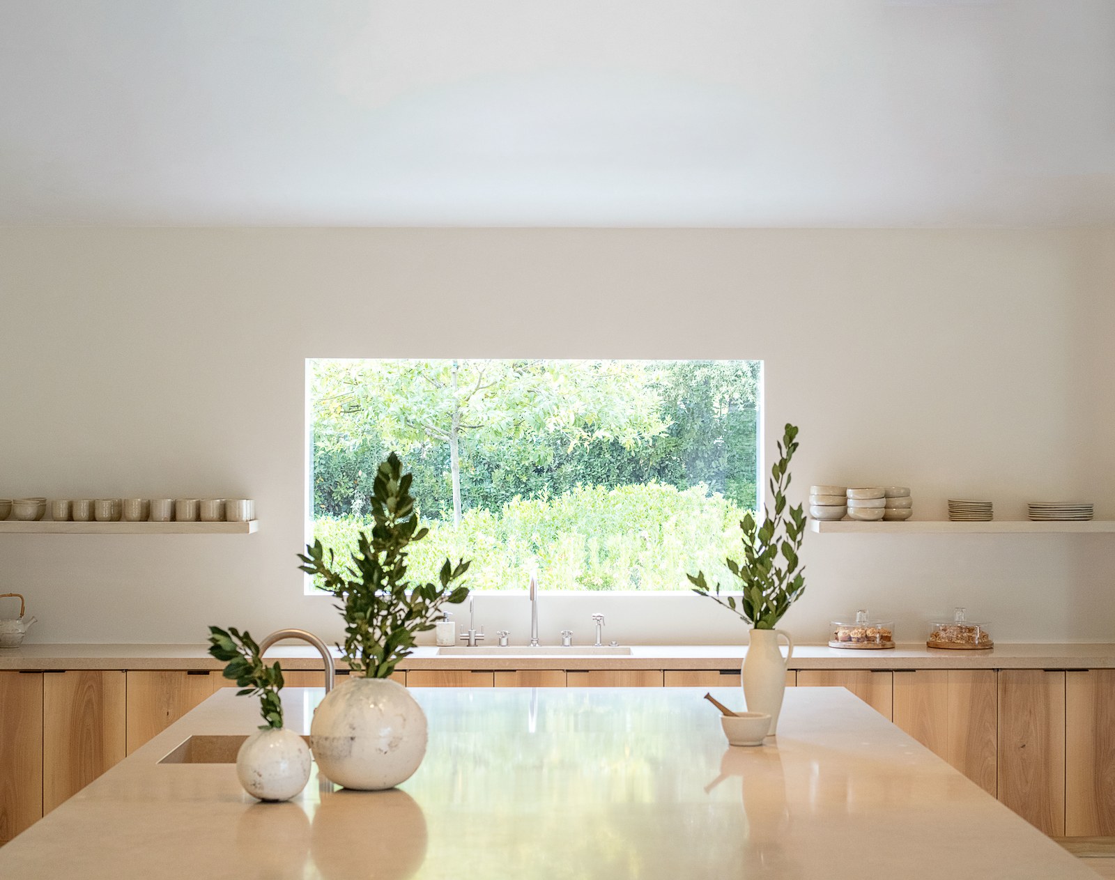 white round vases on a stone kitchen island