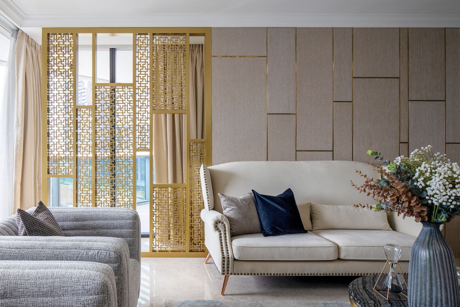 The gold lattice screen brings an opulent touch to the home while the neutral palette keeps the look elegant