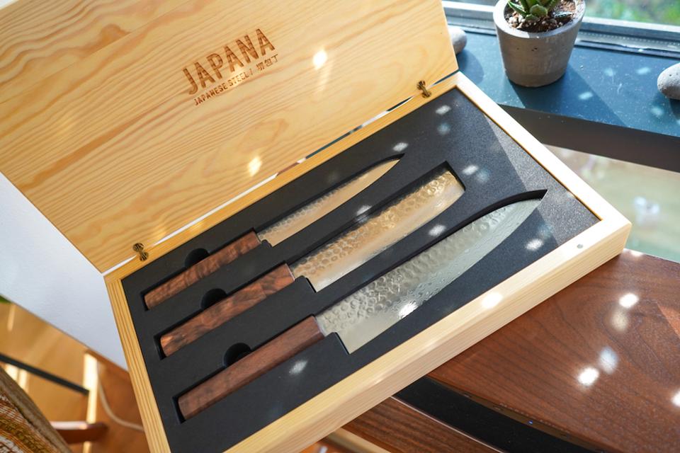 Sakai Kyuba knife set; a paring, vegetable and chef's knife presented in a decorative pine wood box.
