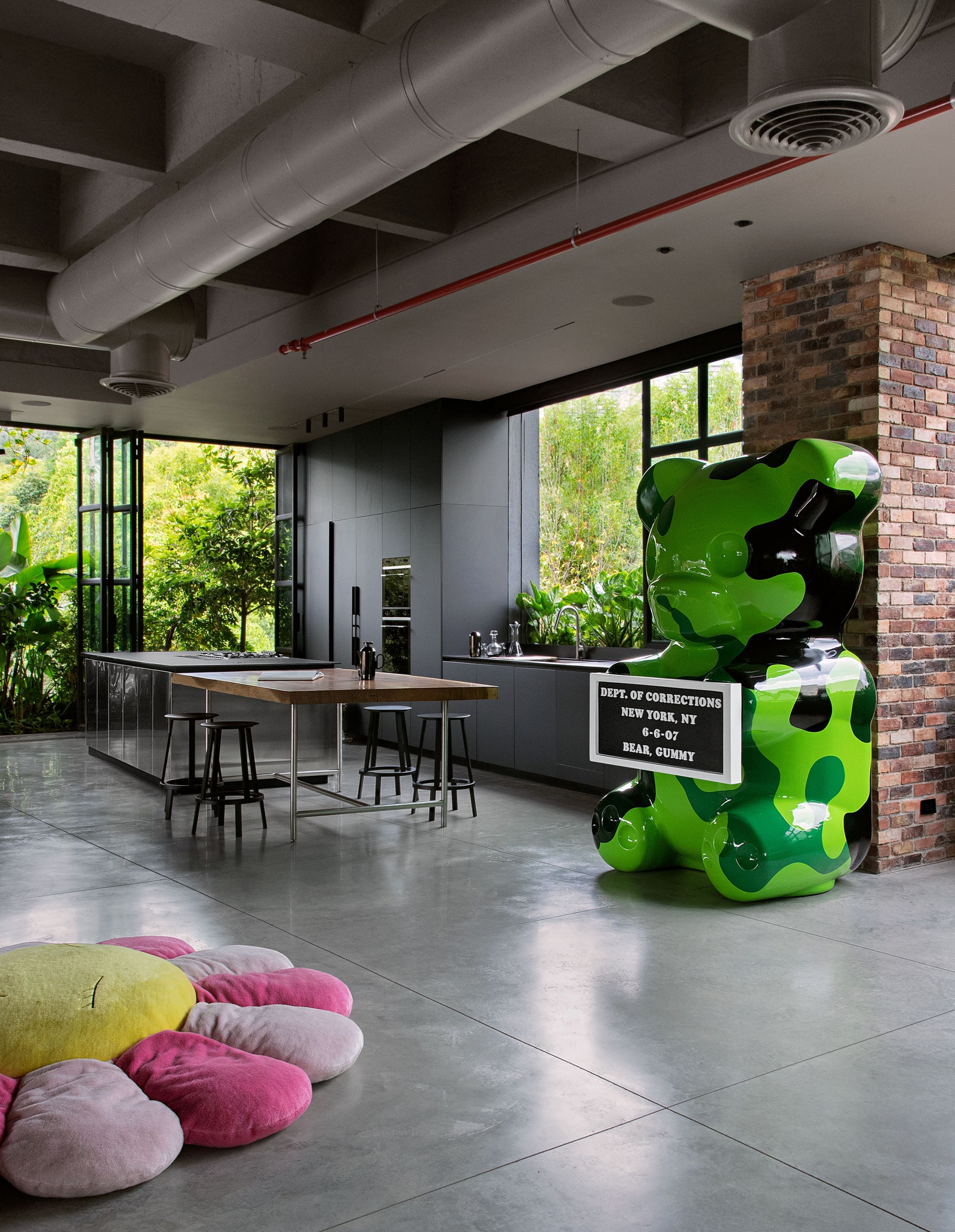 pA Whisbe sculpture and Takashi Murakami floor cushion add jolts of color to the Medelln loft. p 