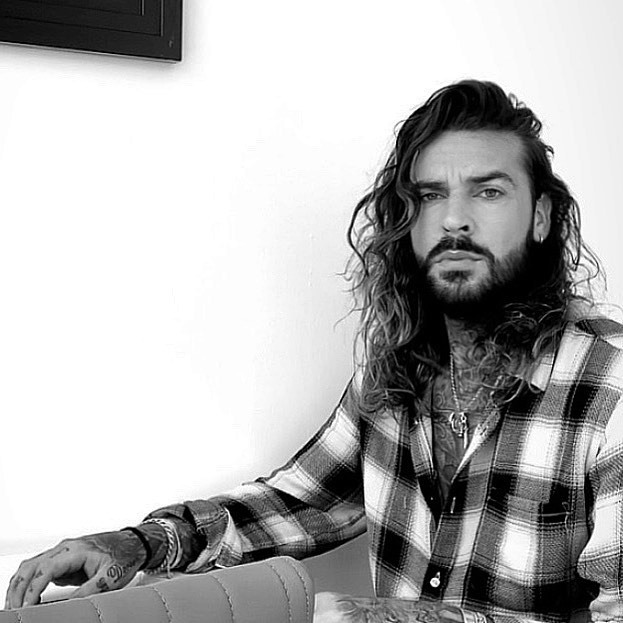 His kitchen/dining area's white wall is the perfect backdrop for a serious picture