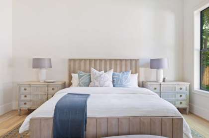 When staging a master bedroom, don't overload a bed with pillows or too-fluffy bedding, said interior designer Cindy Witmer.