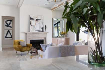 When staging a living room for the real estate market, edit and arrange furniture to make a room look more spacious. If you're using a rug, keep it simple and in a color/shade similar to the flooring beneath it, says Cindy Witmer of Cindy Witmer Designs and Walker Wright of W Abodes.