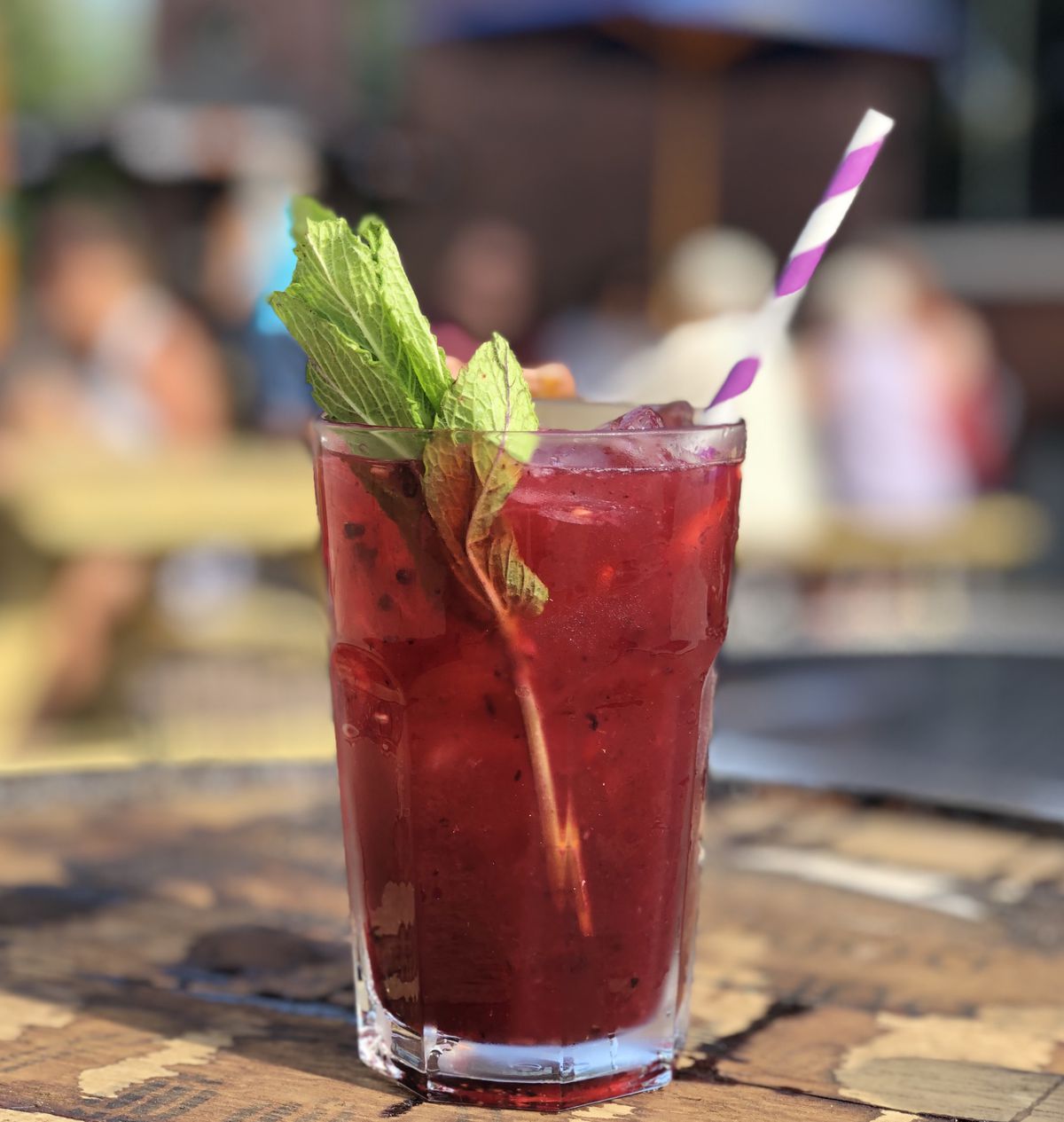 A purple cocktail in a glass