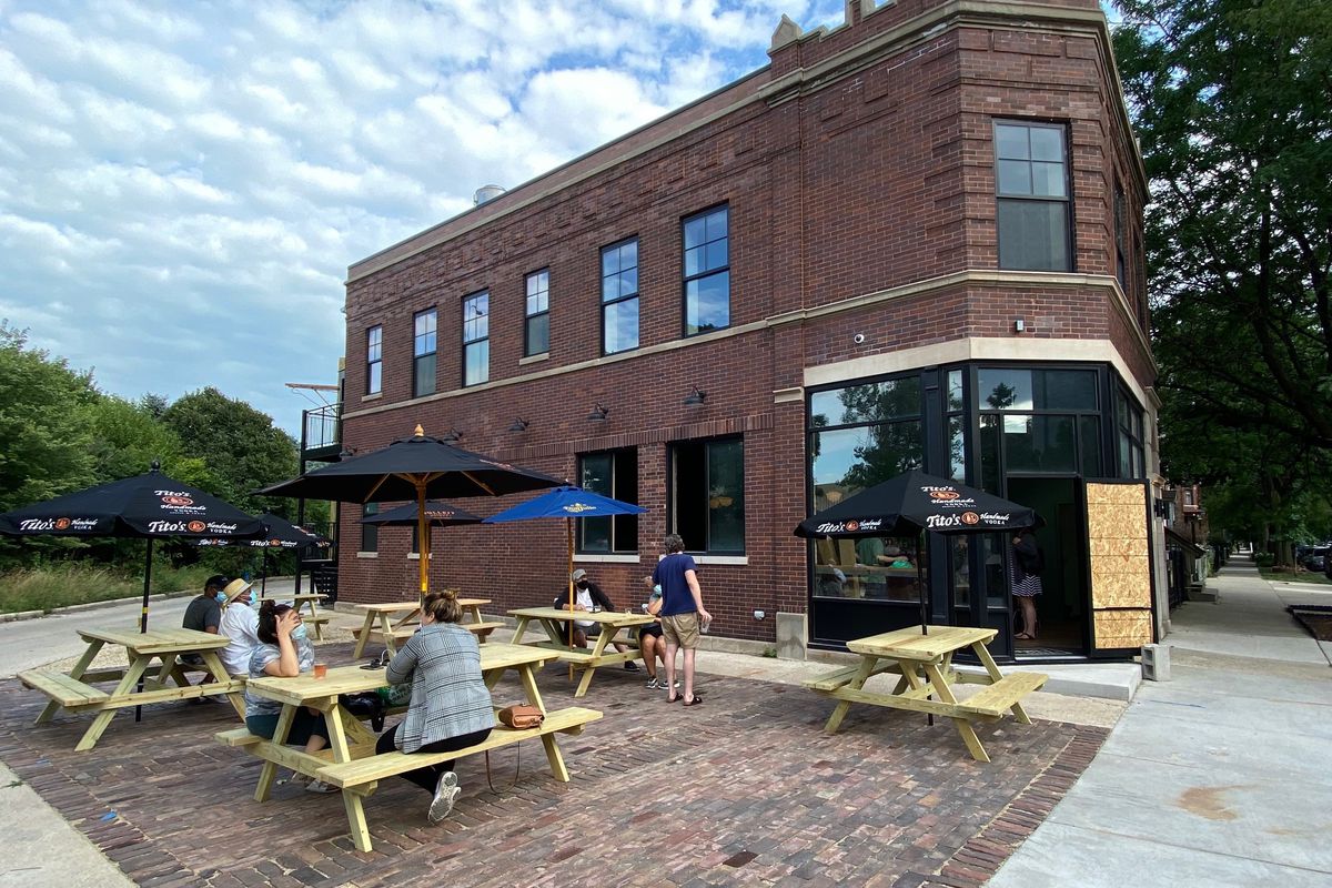 A large brick building with picnic tables