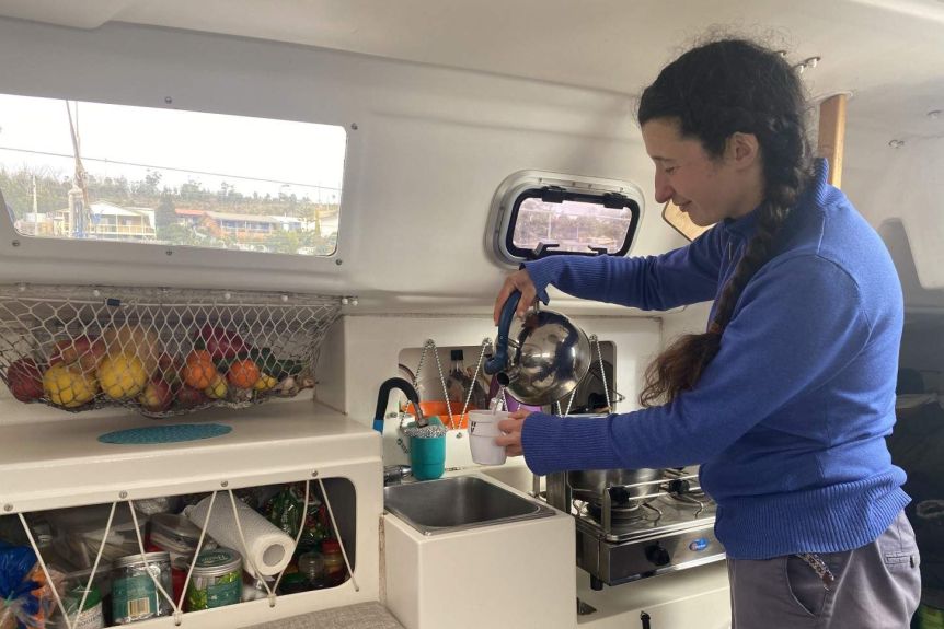 Sailor Carina Juhhova preparing a cup of tea inside her yacht.