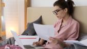 a woman sitting at a table using a laptop