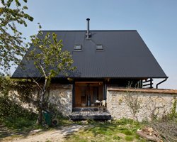 arba builds a timber house between two old stone walls in rural france