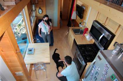 John McCarthy and his wife, Amy Garber, hang out with their dog Winston inside their tiny home along the waterfront in New Haven, Conn., on Thursday Oct. 8, 2020.